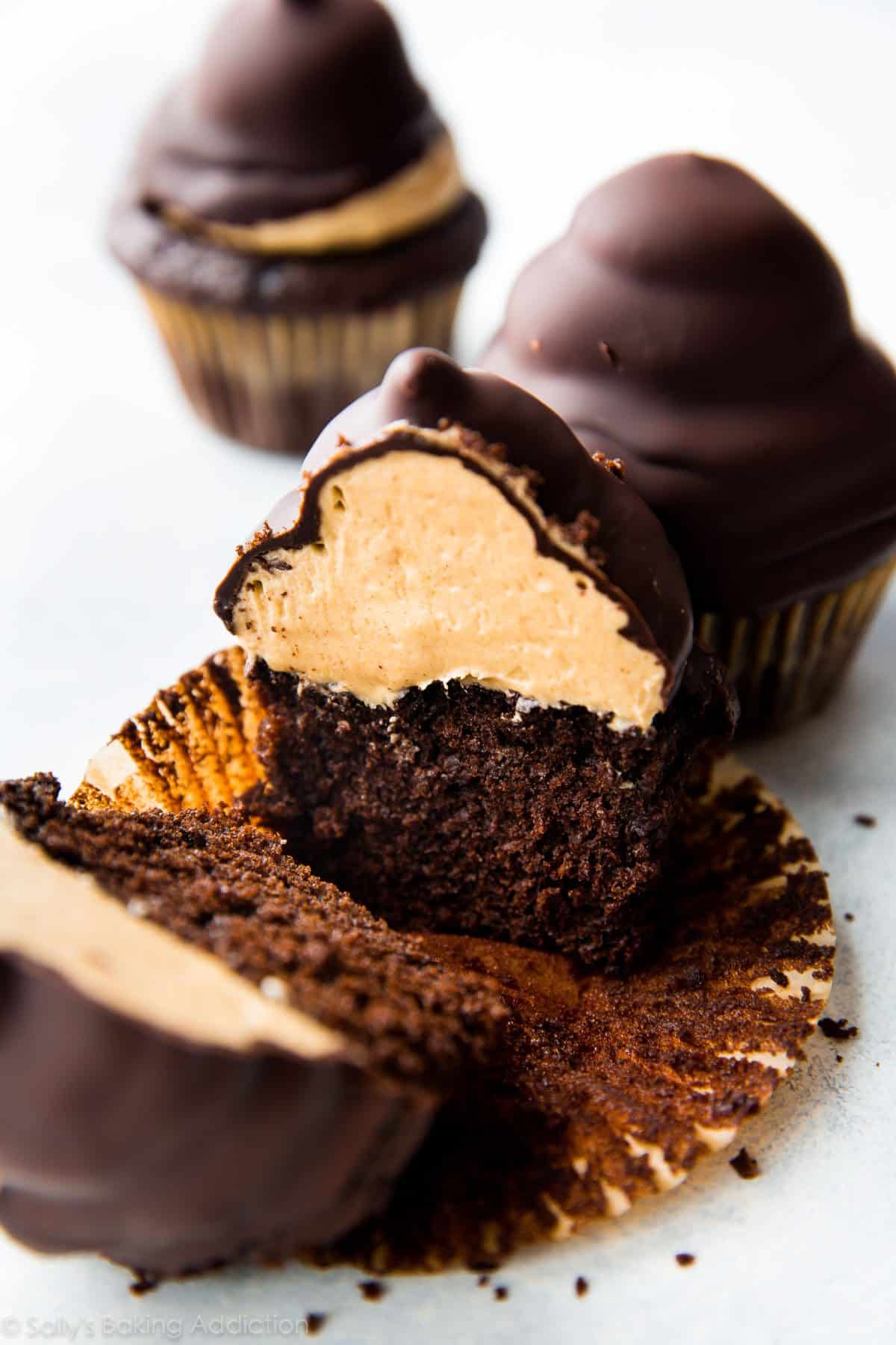 hi-hat cupcake cut in half showing chocolate cupcake topped with peanut butter frosting inside a chocolate coating