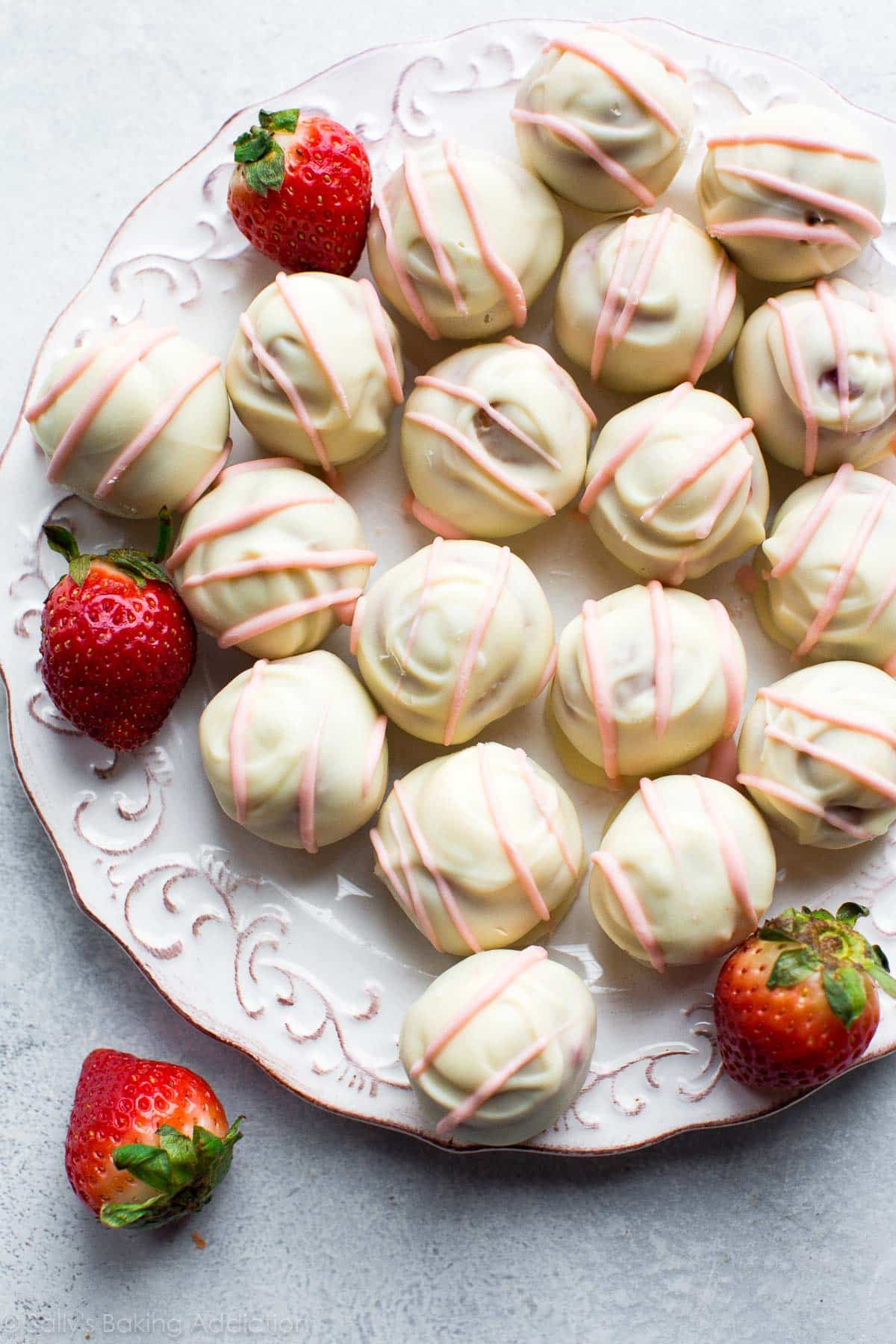 overhead image of strawberry cheesecake truffles on a white plate