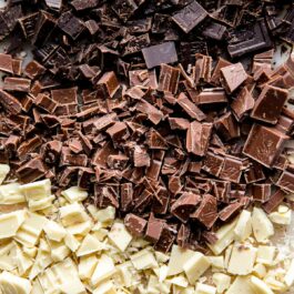 chopped white chocolate, milk chocolate, and dark chocolate on a cutting board