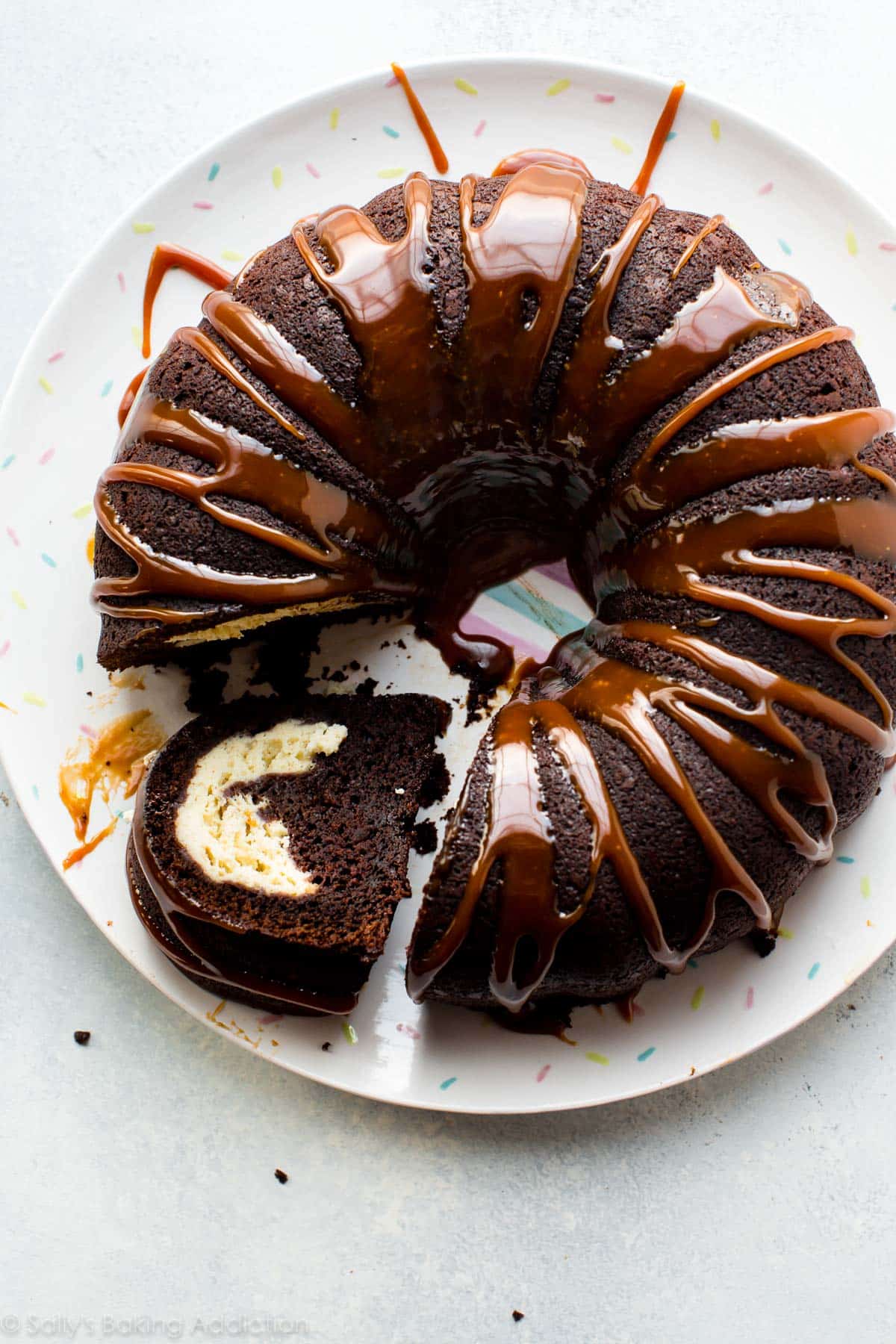 overhead image of chocolate cream cheese bundt cake with salted caramel drizzle on top
