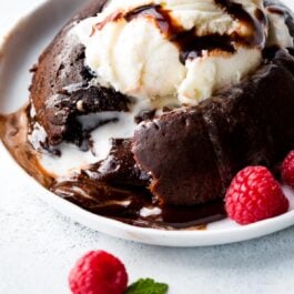 chocolate lava cake with a scoop of vanilla ice cream on a white plate