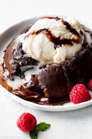 chocolate lava cake with a scoop of vanilla ice cream on a white plate.
