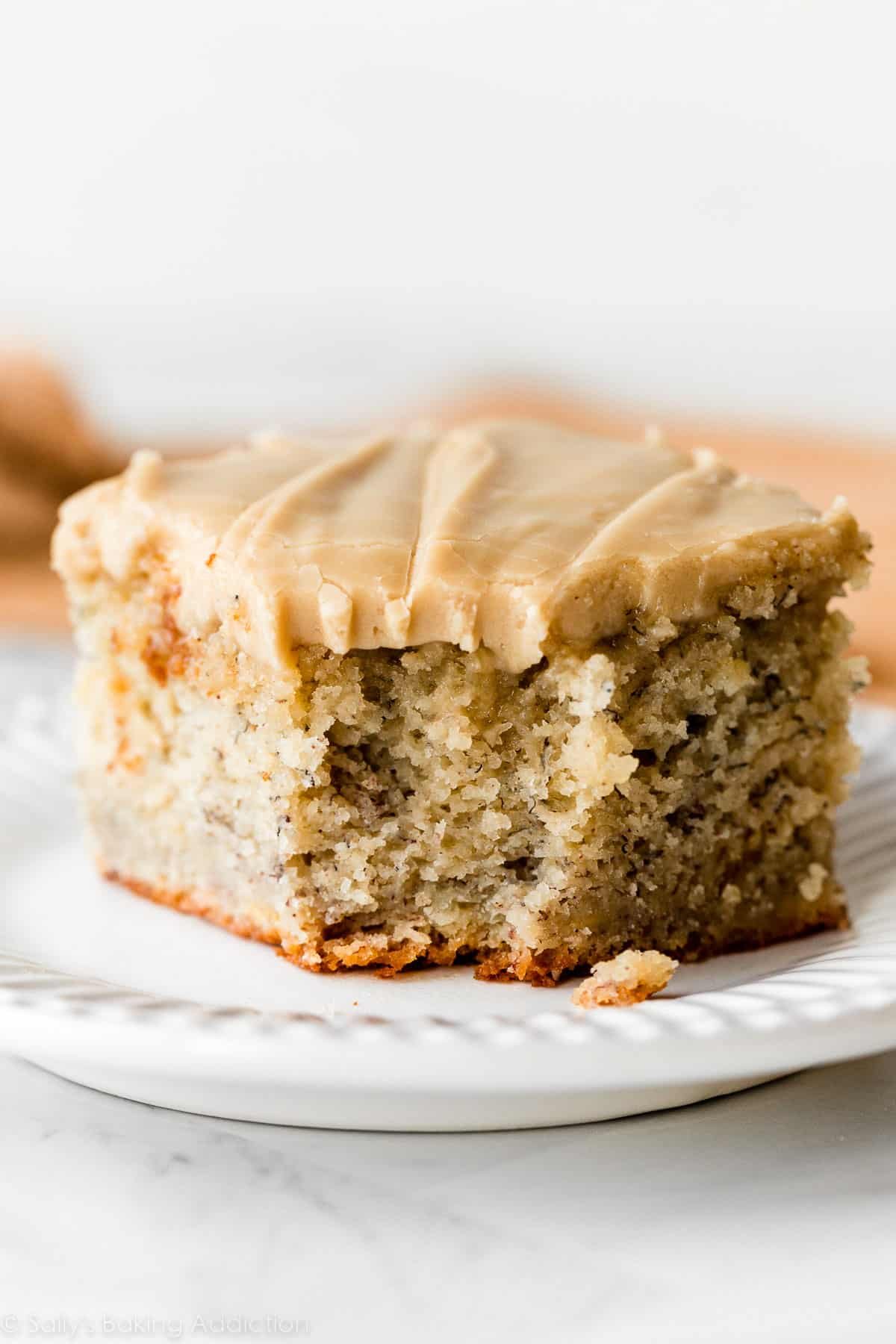 banana cake slice with salted caramel frosting on top.