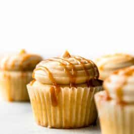 cupcakes topped with salted caramel frosting and a drizzle of salted caramel