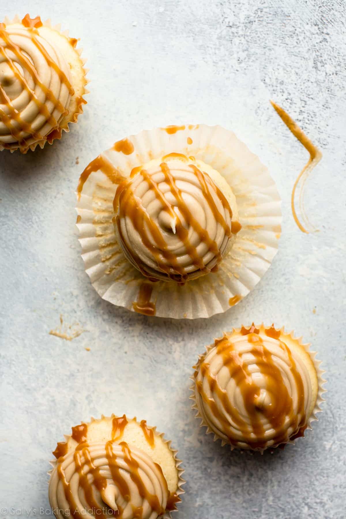 overhead image of cupcakes topped with salted caramel frosting and a drizzle of salted caramel