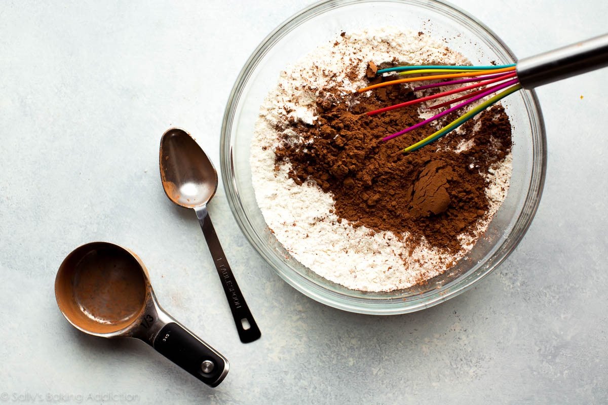dry ingredients for chocolate whoopie pies in a glass bowl with a whisk