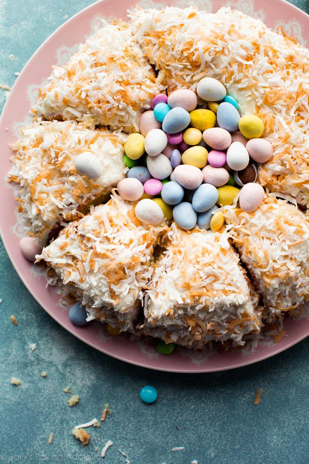 coconut Easter nest cake cut into slices with candy in the center