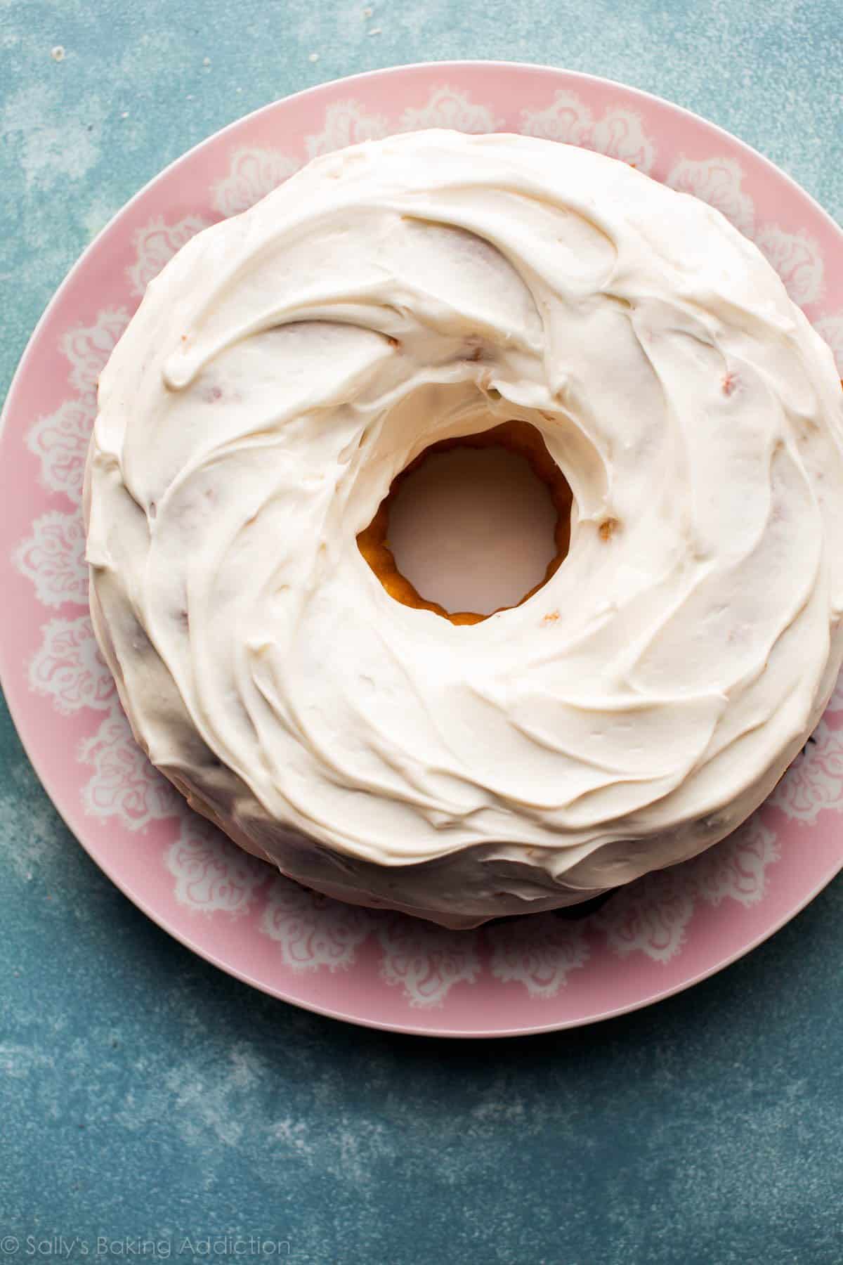 Easter nest bundt cake with cream cheese frosting layer on pink plate