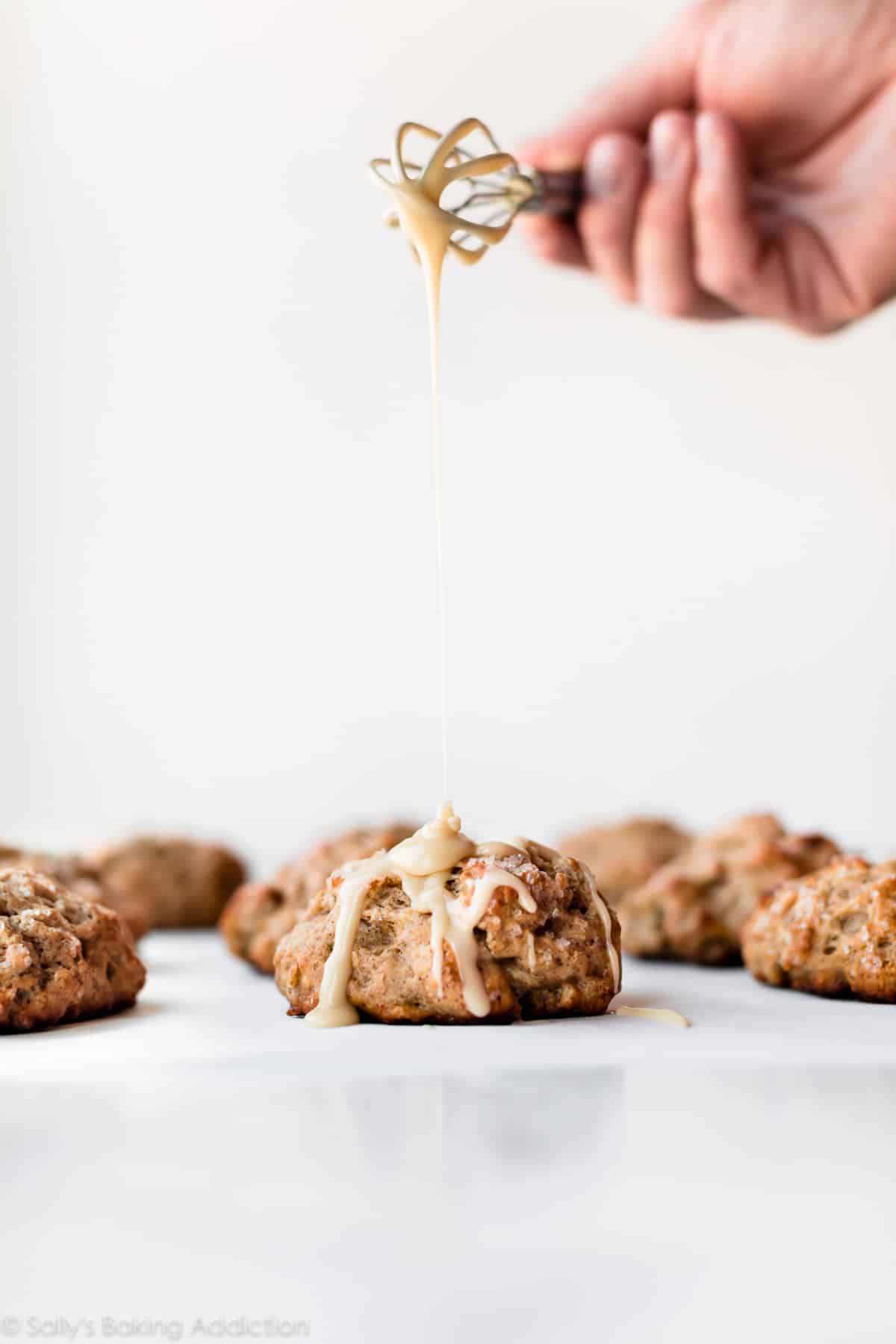 Drizzling maple icing on banana scones