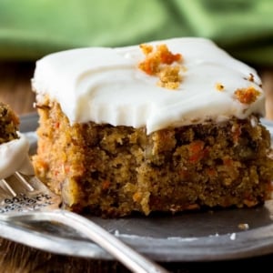 slice of pineapple carrot cake on a silver plate with a fork