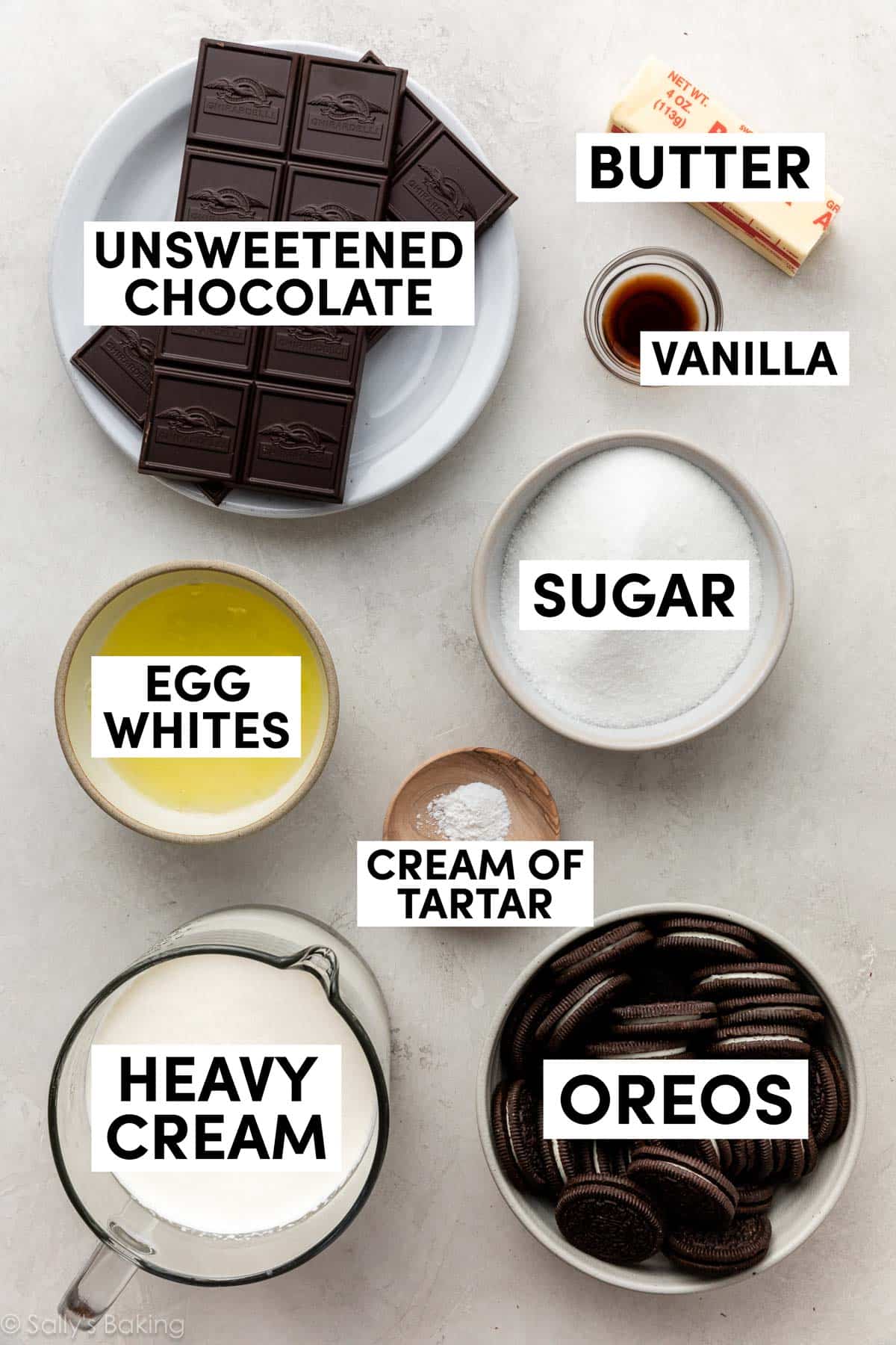 ingredients in bowls including oreos, heavy cream, cream of tartar, sugar, and egg whites.