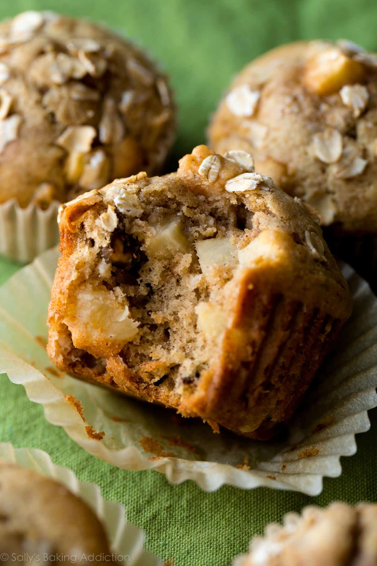 apple cinnamon muffins with a bite taken from one