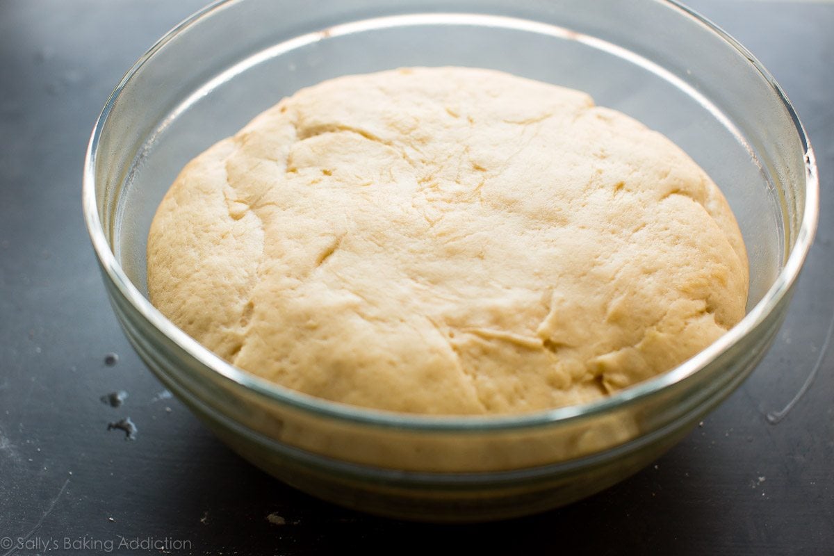 sticky bun dough after rising in a glass bowl
