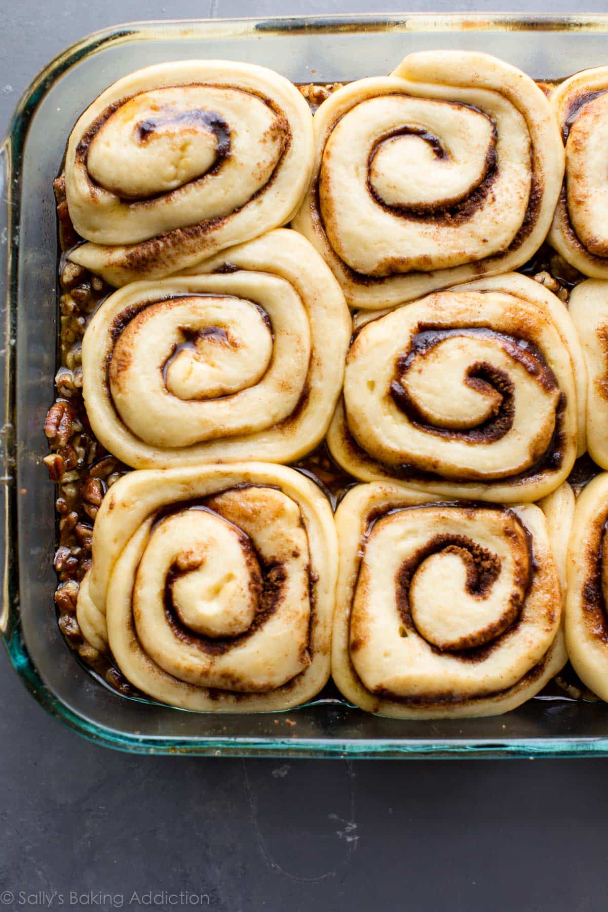maple pecan sticky buns in a glass baking dish before baking