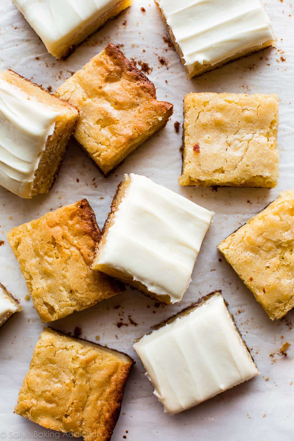 white chocolate brownies cut into squares topped with frosting