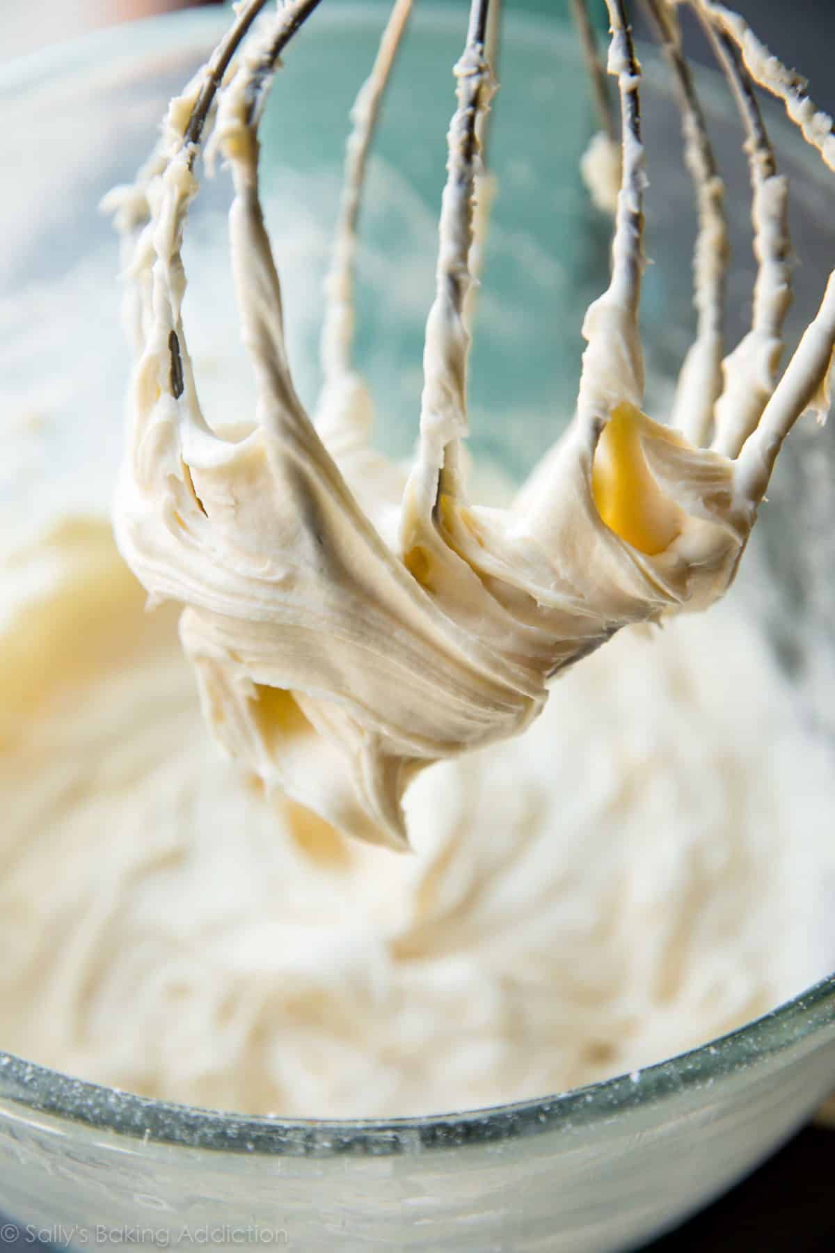 cream cheese frosting in a glass bowl with a whisk attachment