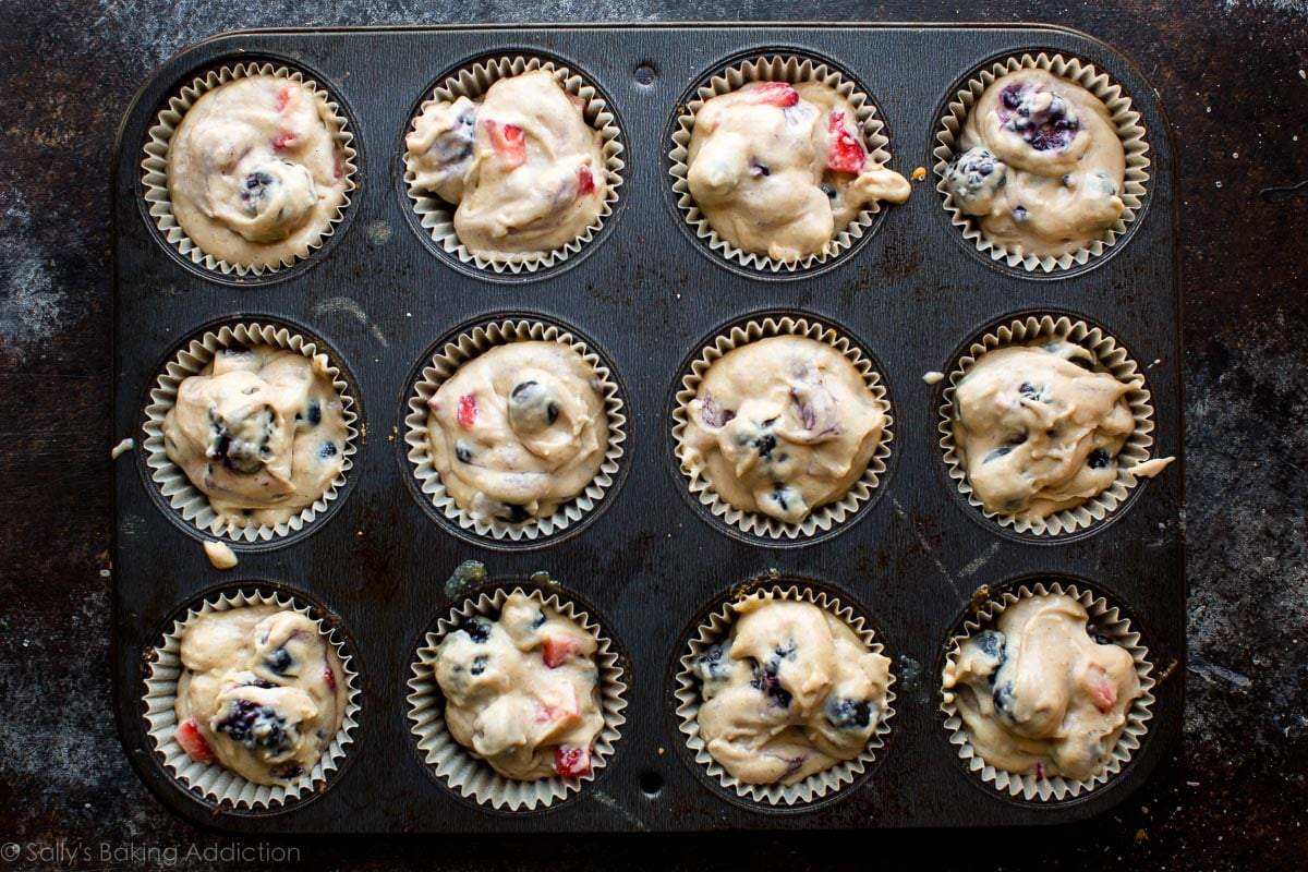 mixed berry muffin batter in a muffin pan