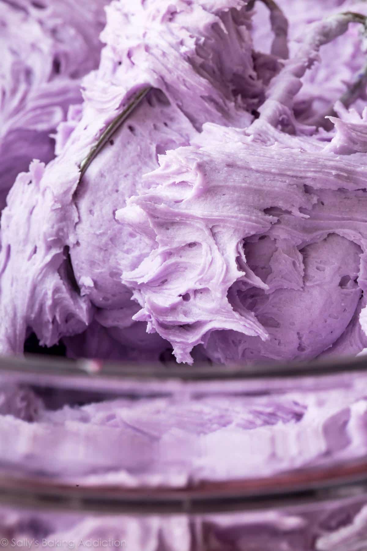 purple buttercream frosting in a glass bowl