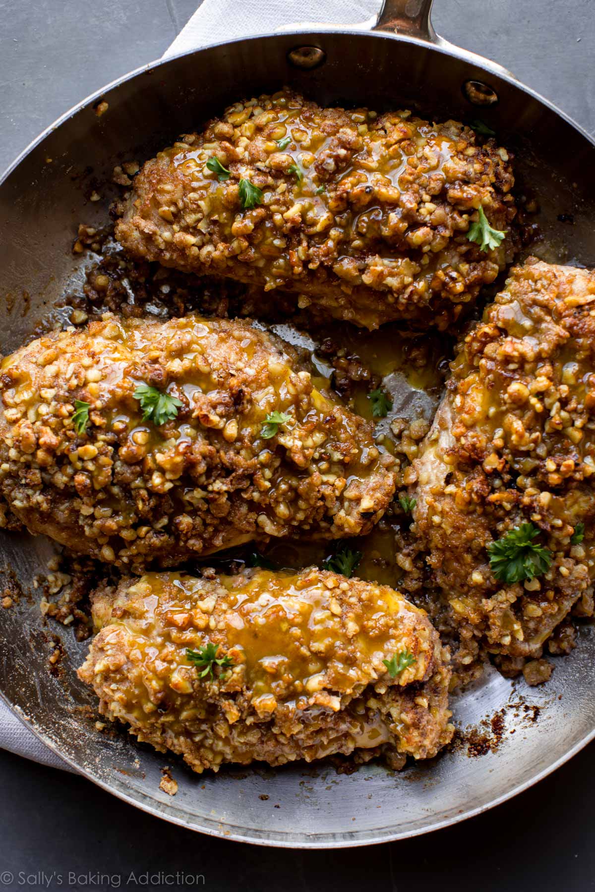 overhead image of walnut crusted chicken in a skillet