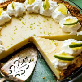 key lime pie with a pie server and a slice removed