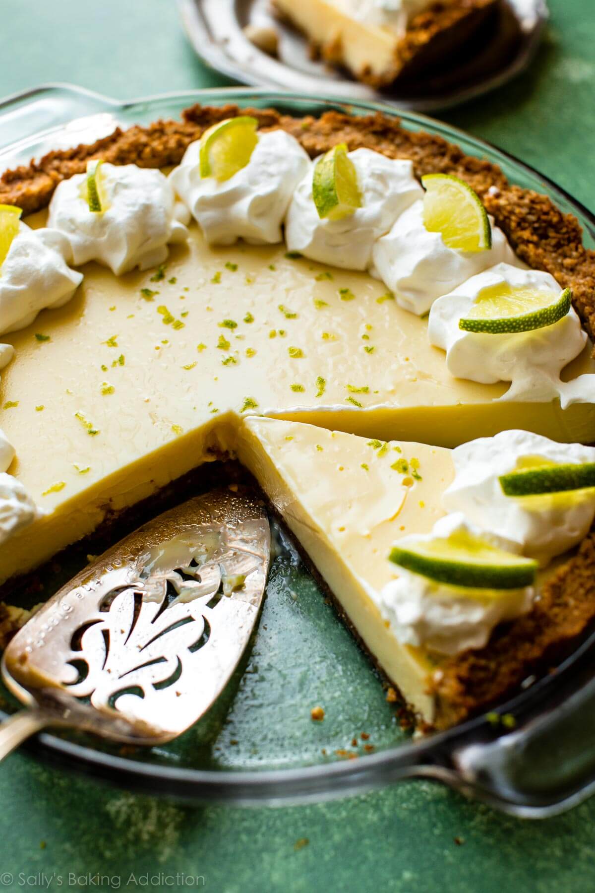 key lime pie with a pie server and a slice removed