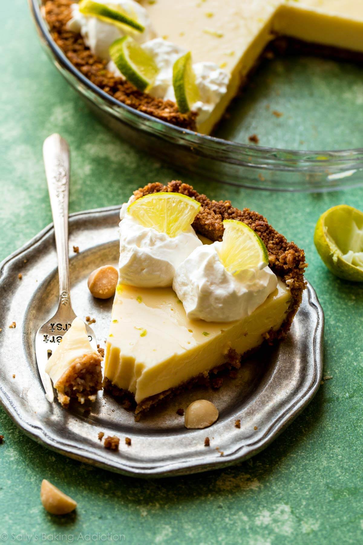 slice of key lime pie on a silver plate with a fork