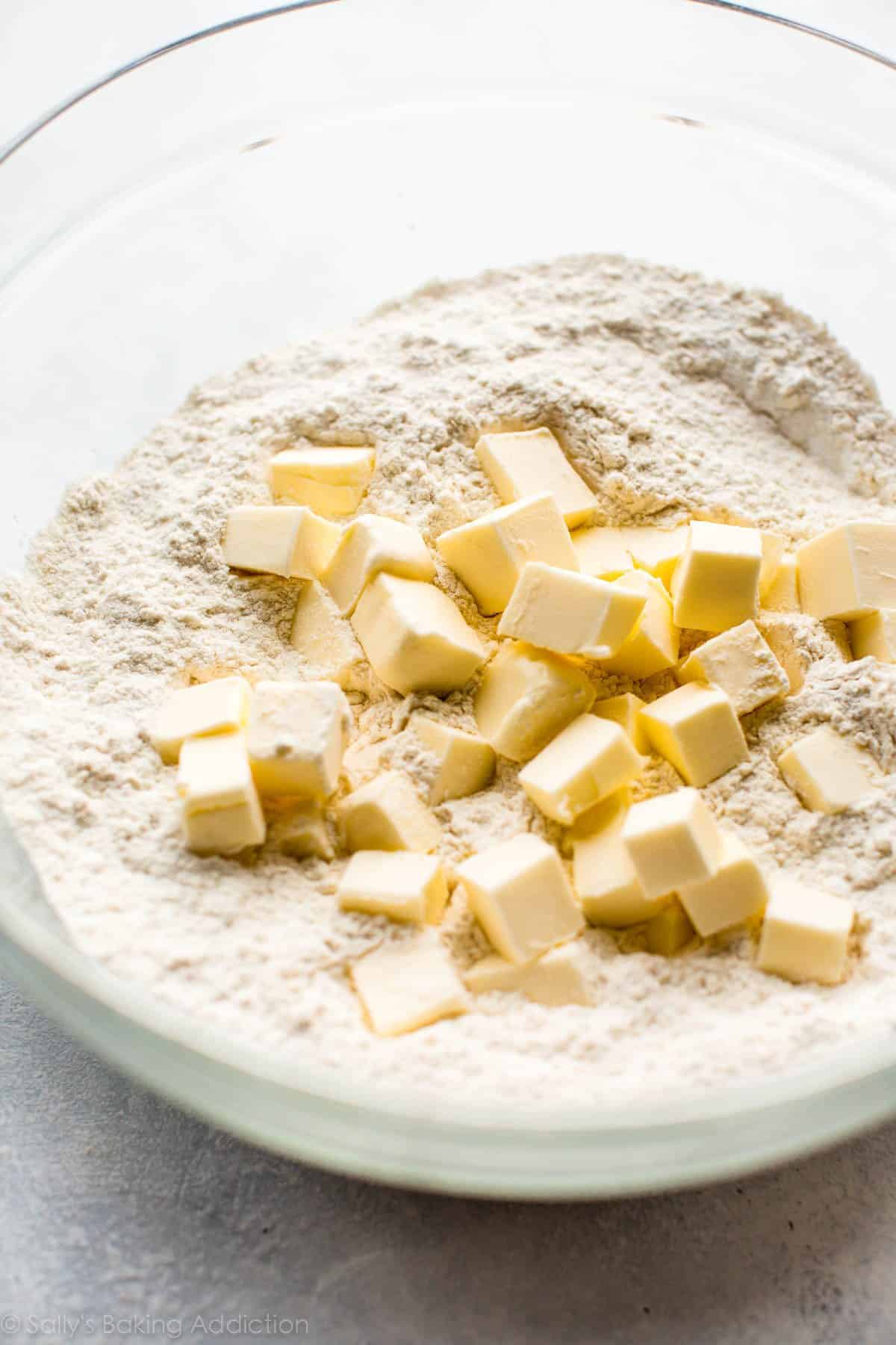 butter cubes and flour for biscuit dough in a glass bowl