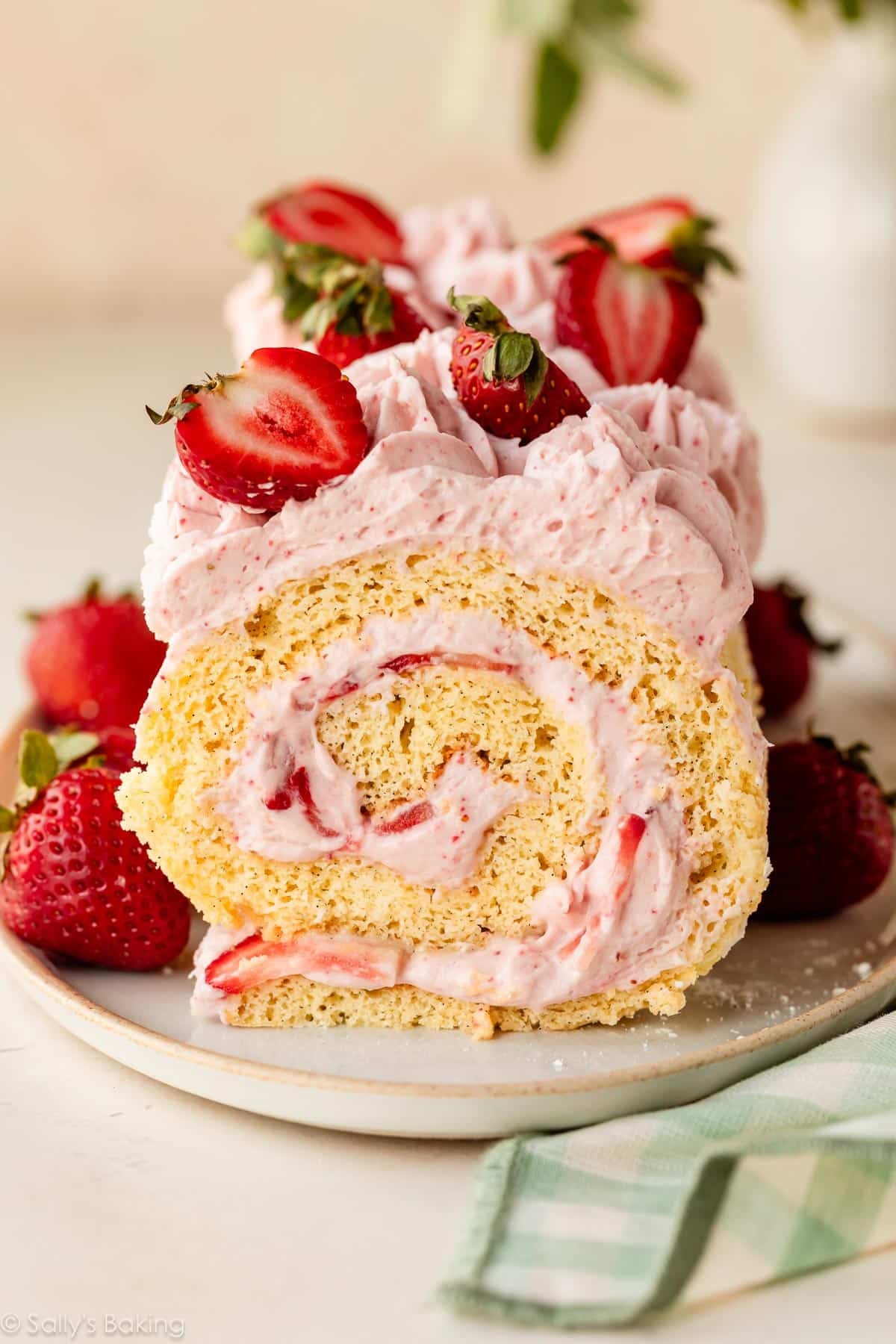strawberry cake roll with strawberries on top.
