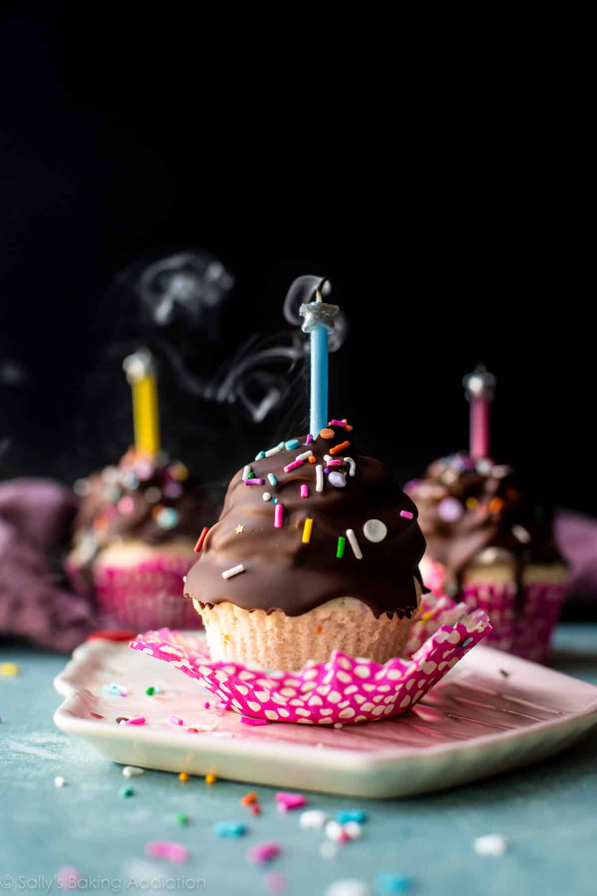 birthday cupcakes with chocolate coating and candles