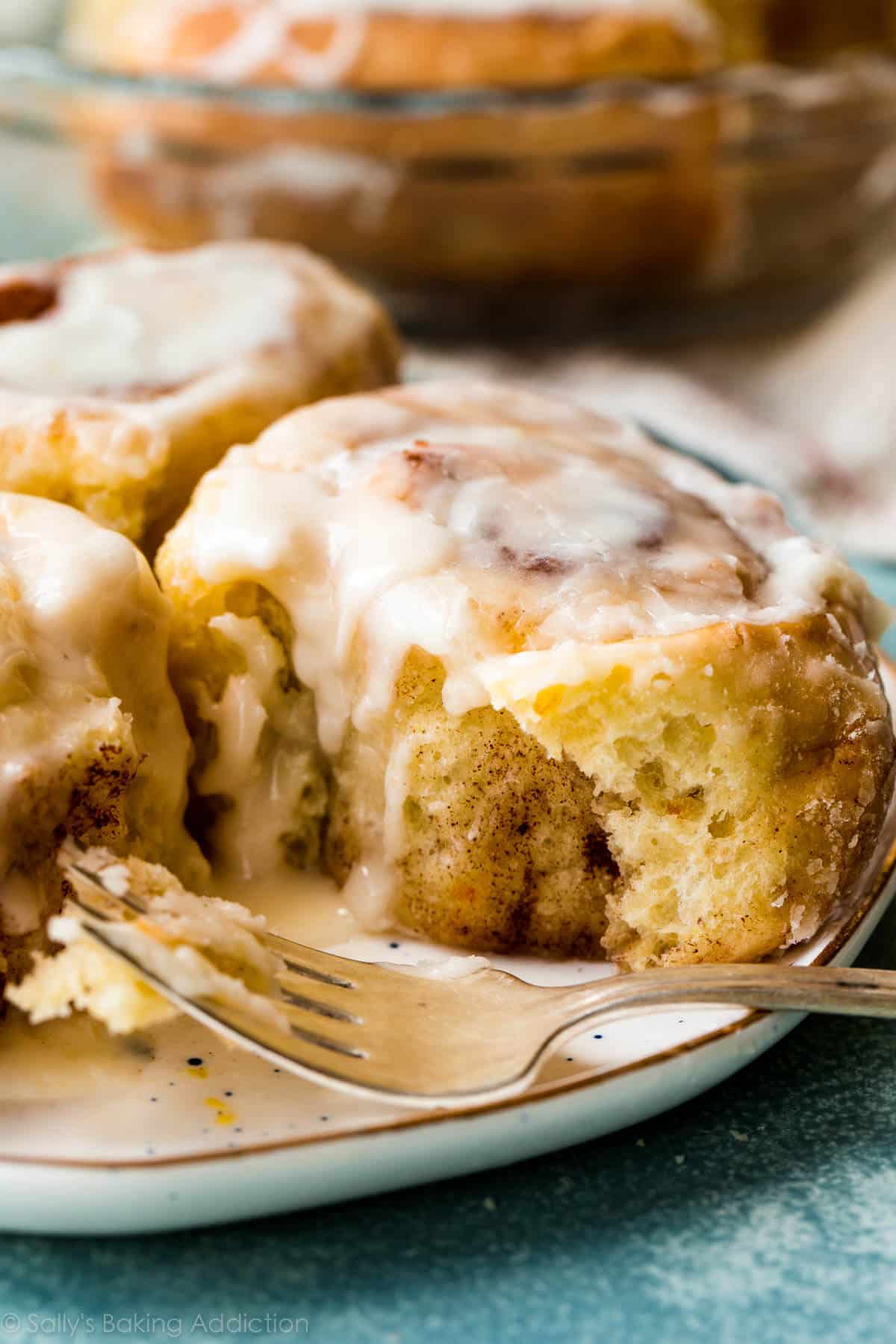 orange sweet rolls on a plate with a fork