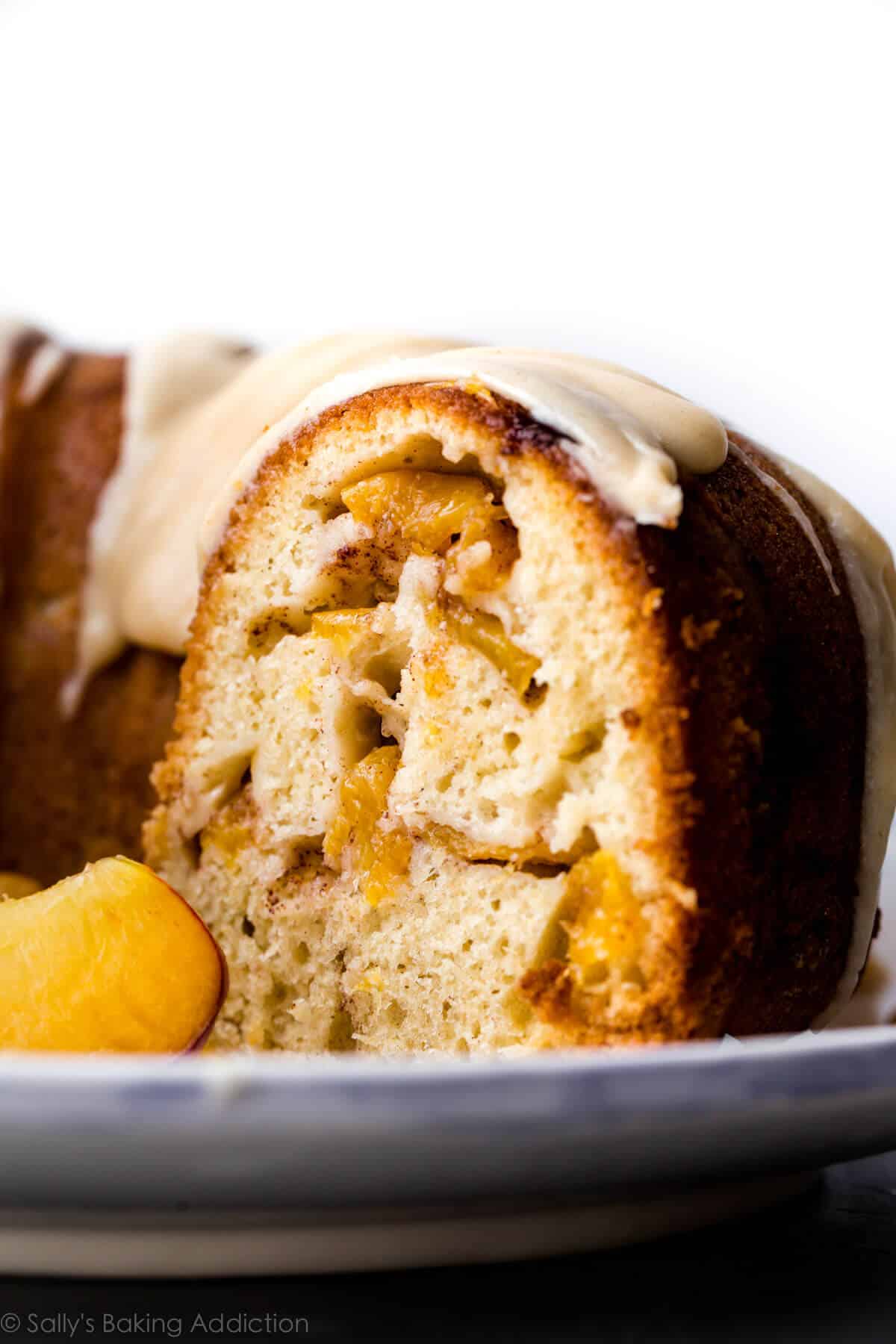 side view of peach bundt cake on a serving plate