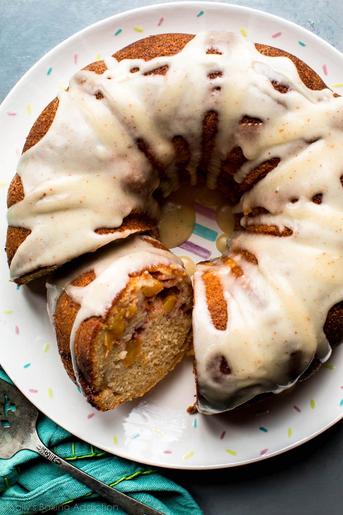 overhead image of peach bundt cake with brown butter icing on a serving plate