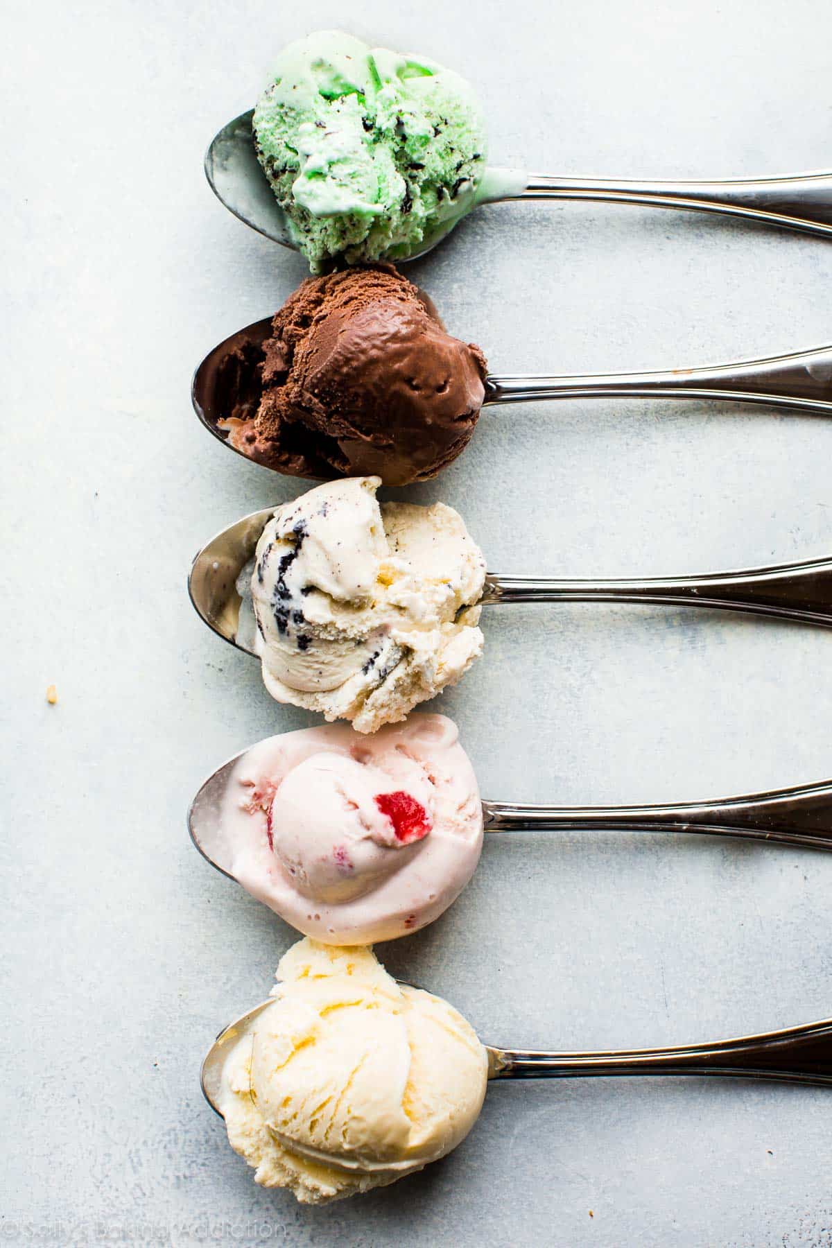spoonfuls of various ice cream flavors in a straight line