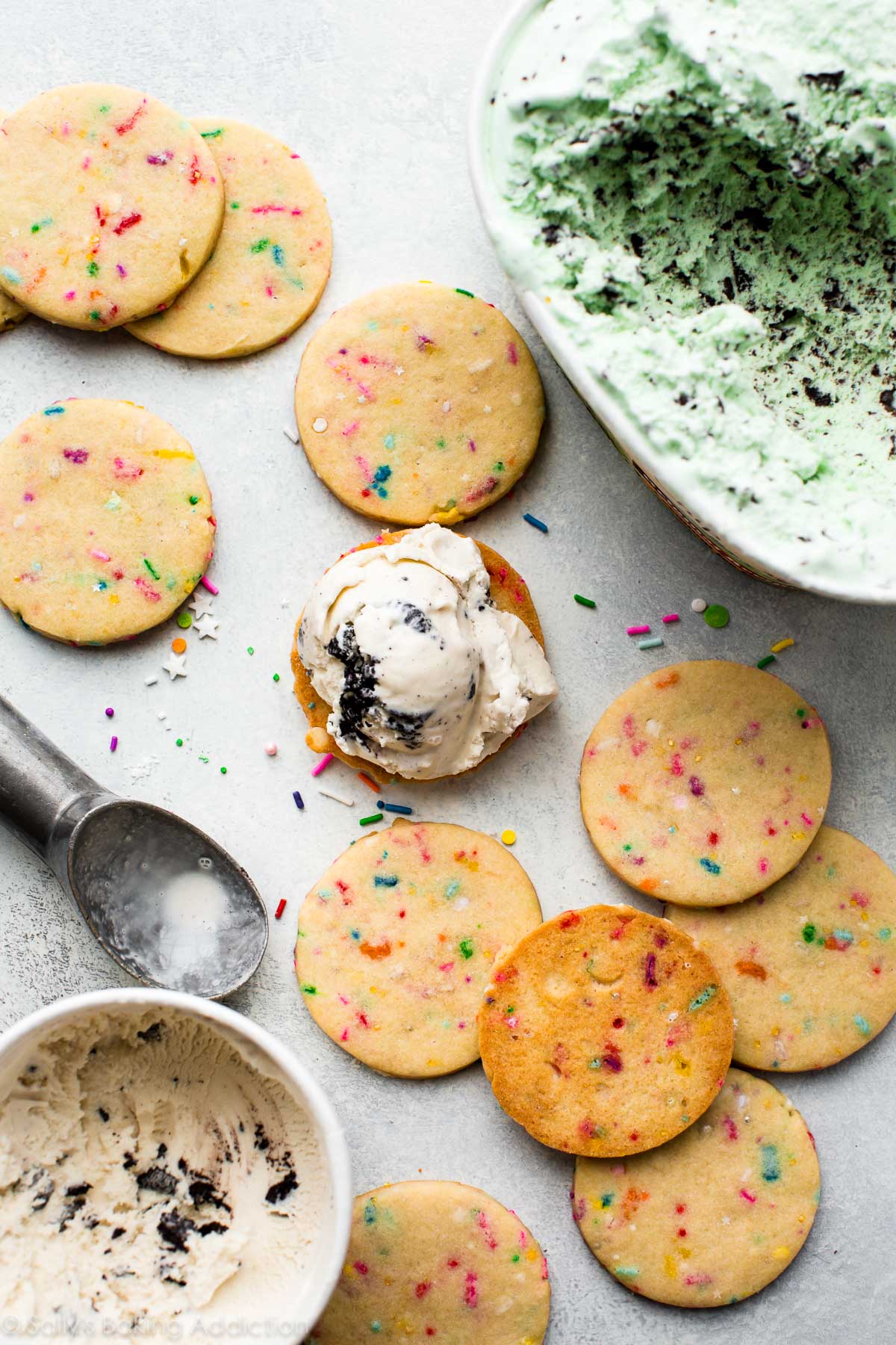 sprinkle sugar cookies and cartons of ice cream with an ice cream scoop
