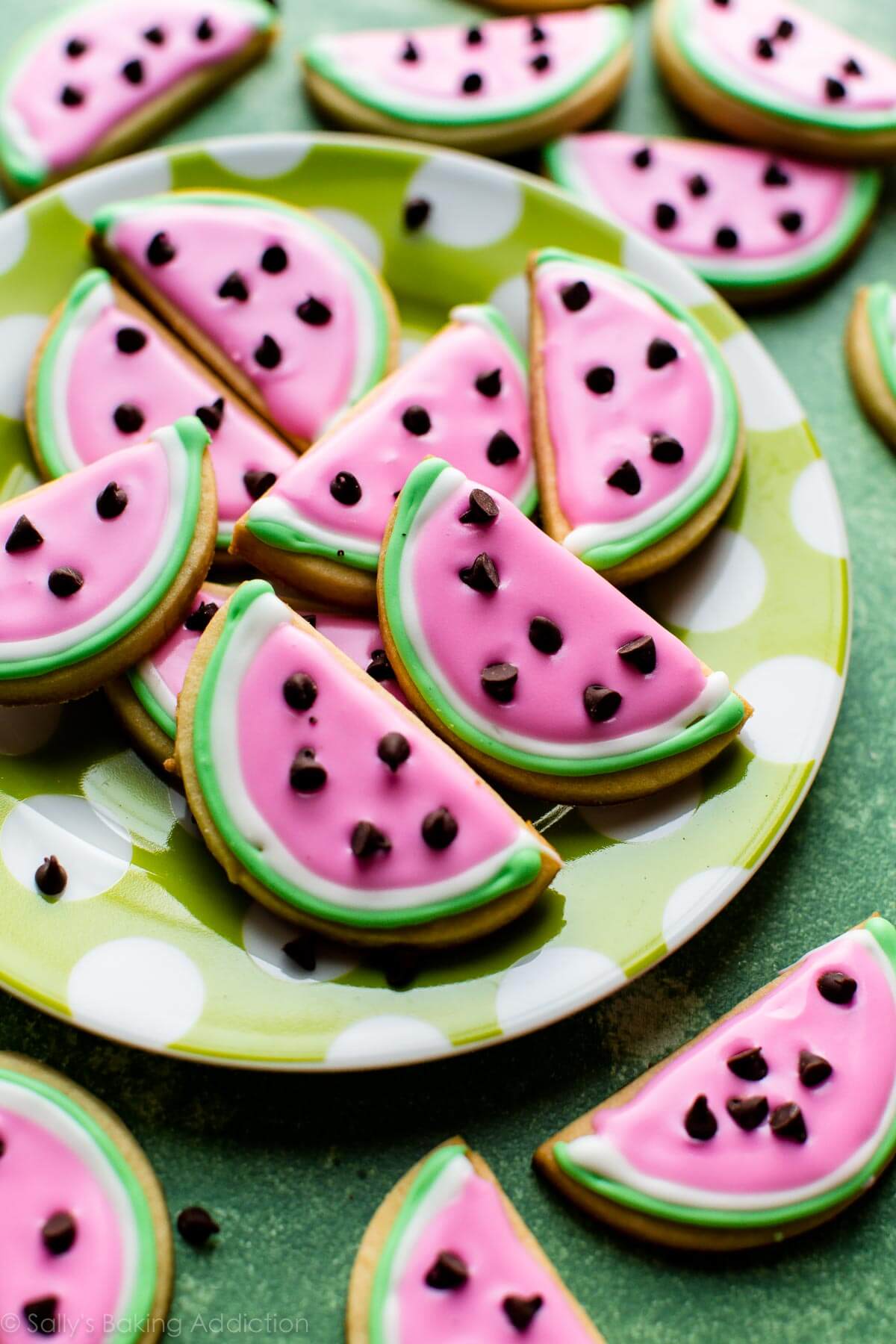 watermelon sugar cookies on a green and white polka dot plate
