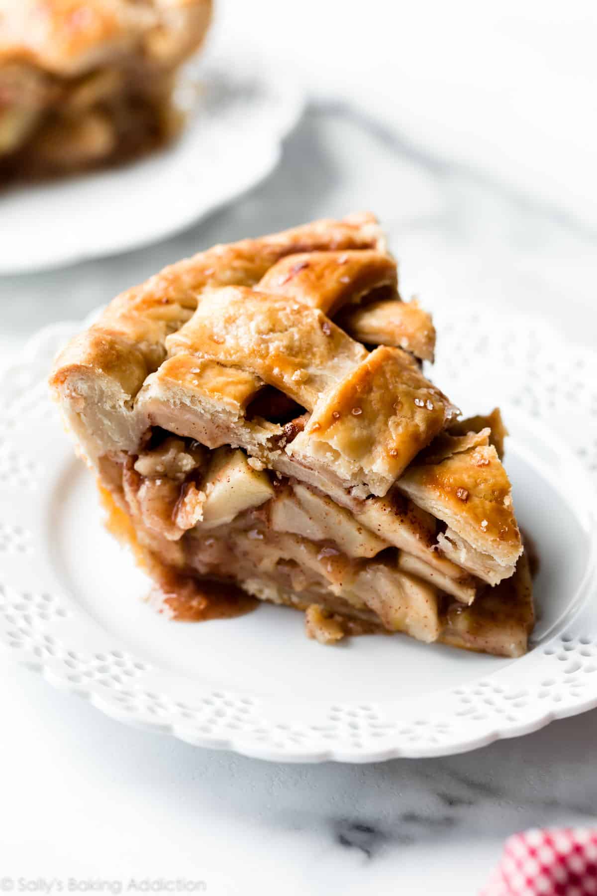 deep dish apple pie slice on white plate