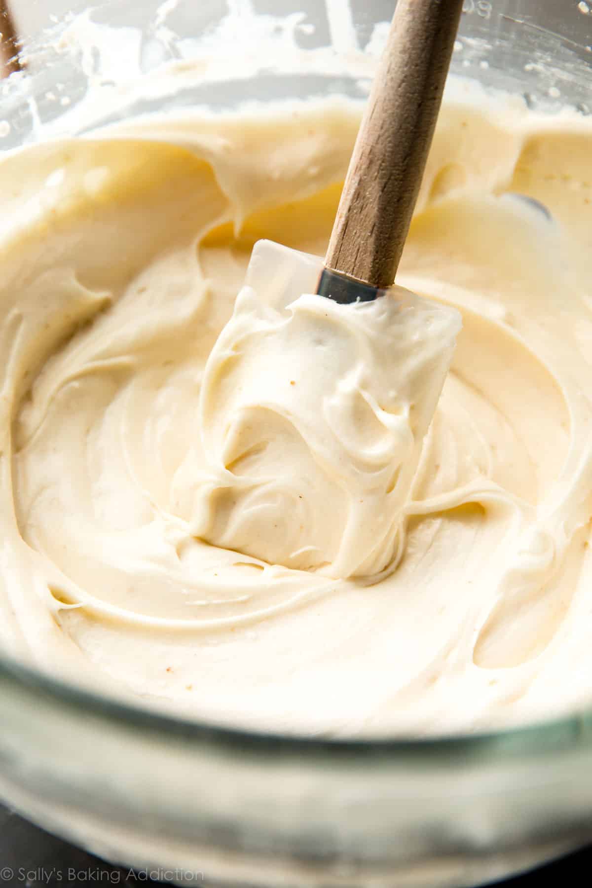 brown butter cream cheese frosting in a glass bowl with a spatula