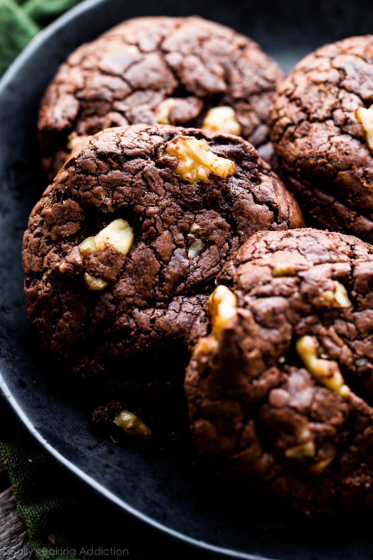 brownie walnut cookies on a black plate