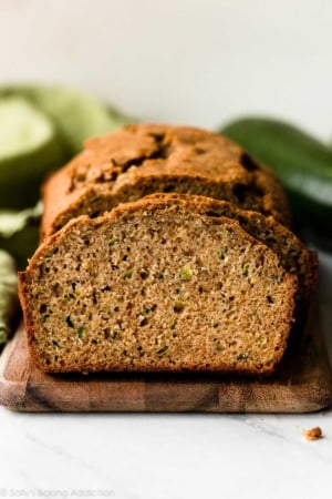 sliced loaf of zucchini bread on wooden cutting board
