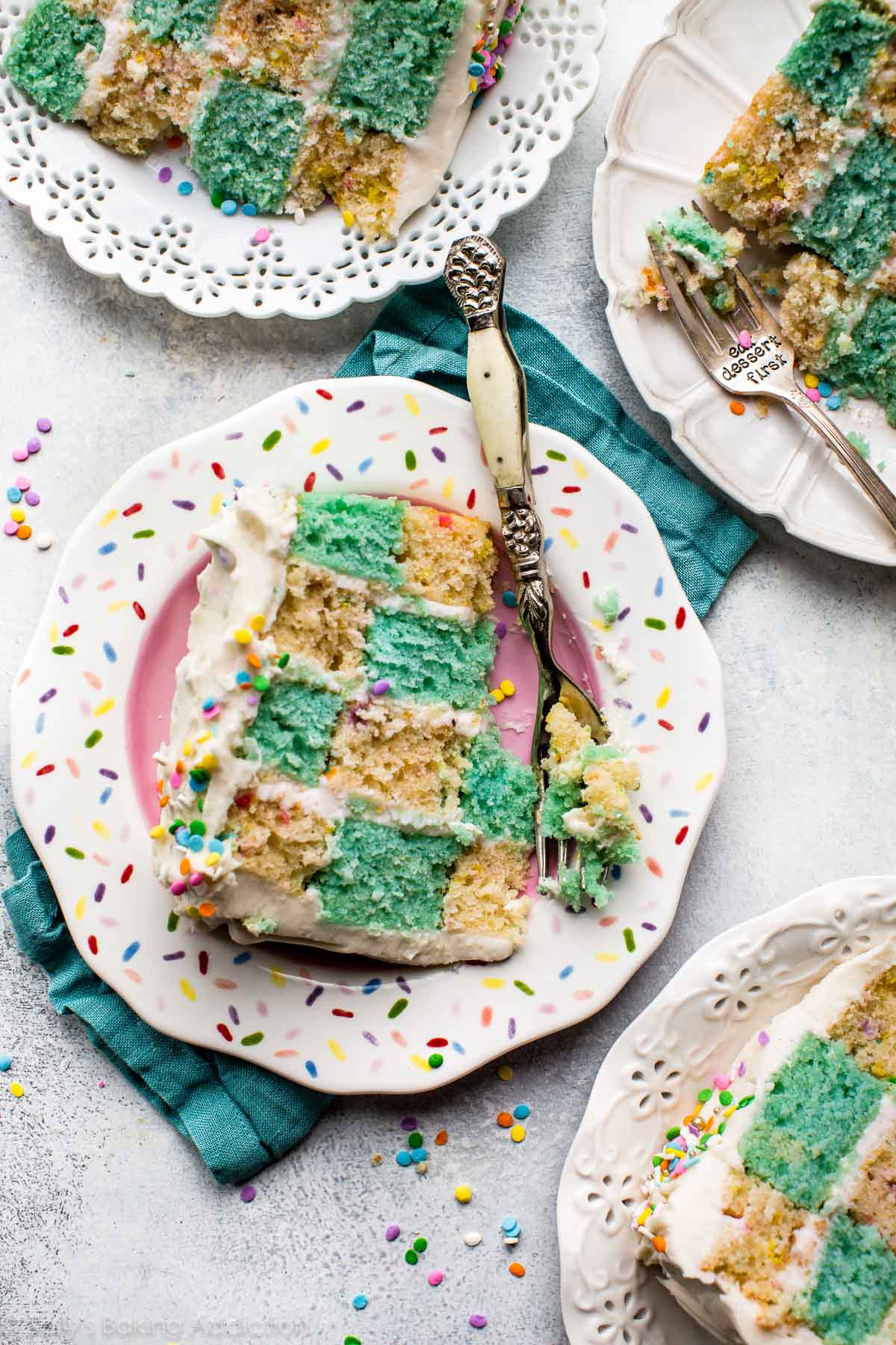 slices of checkerboard cake on plates with forks