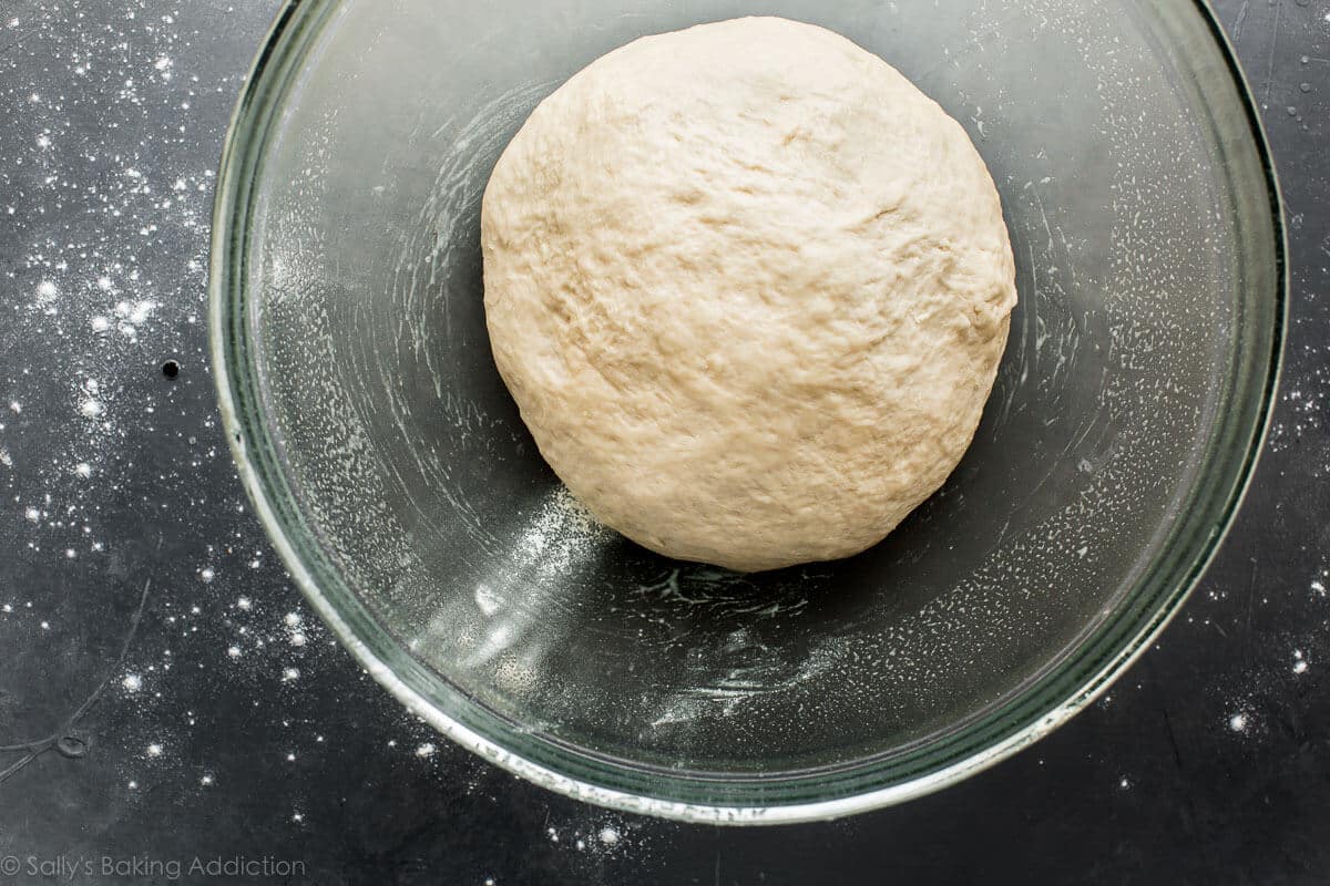 pretzel roll dough in a glass bowl before rising