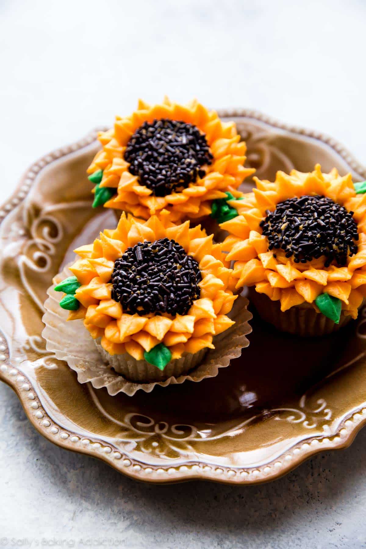sunflower cupcakes on a gold plate