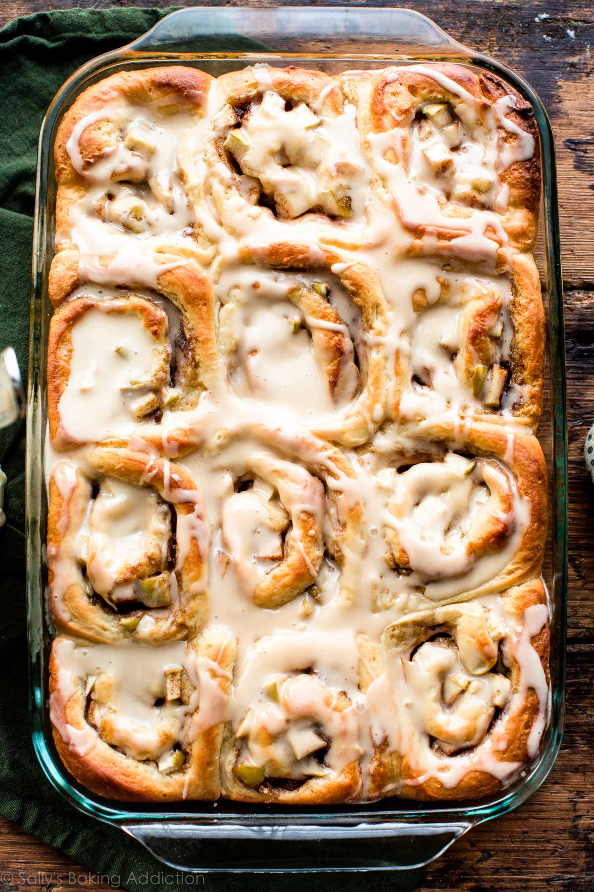 overhead image of apple cinnamon rolls with caramel icing in a 9x13 glass baking dish