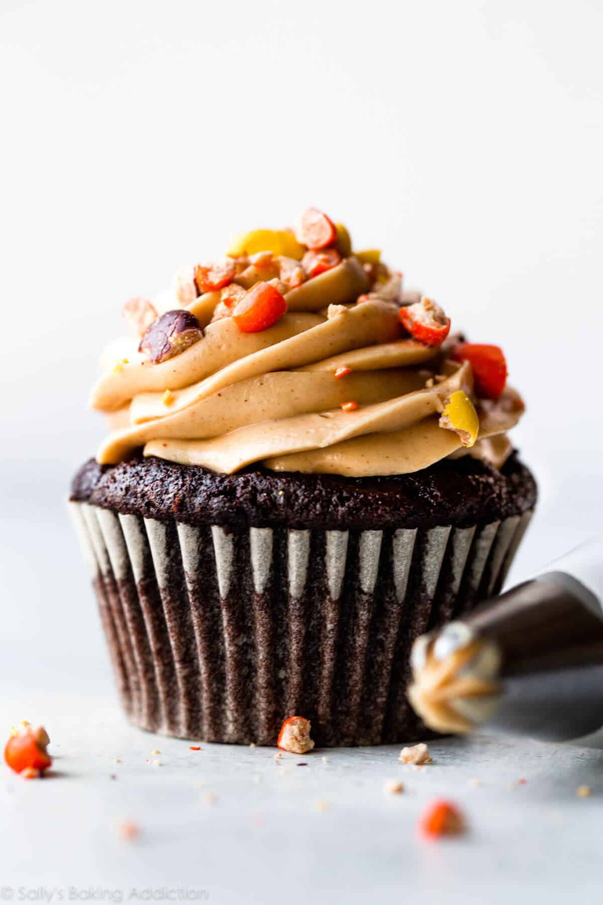 dark chocolate cupcake with peanut butter frosting and crushed Reese's Pieces