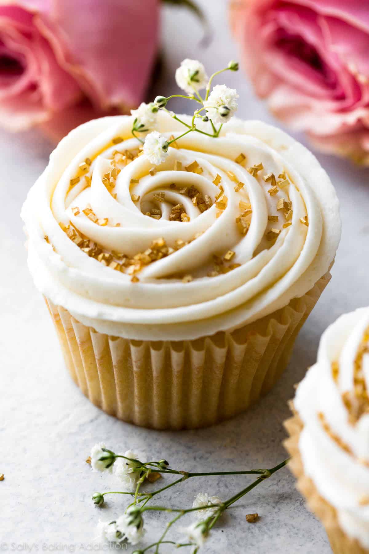 vanilla wedding cupcake with champagne frosting and gold sprinkles