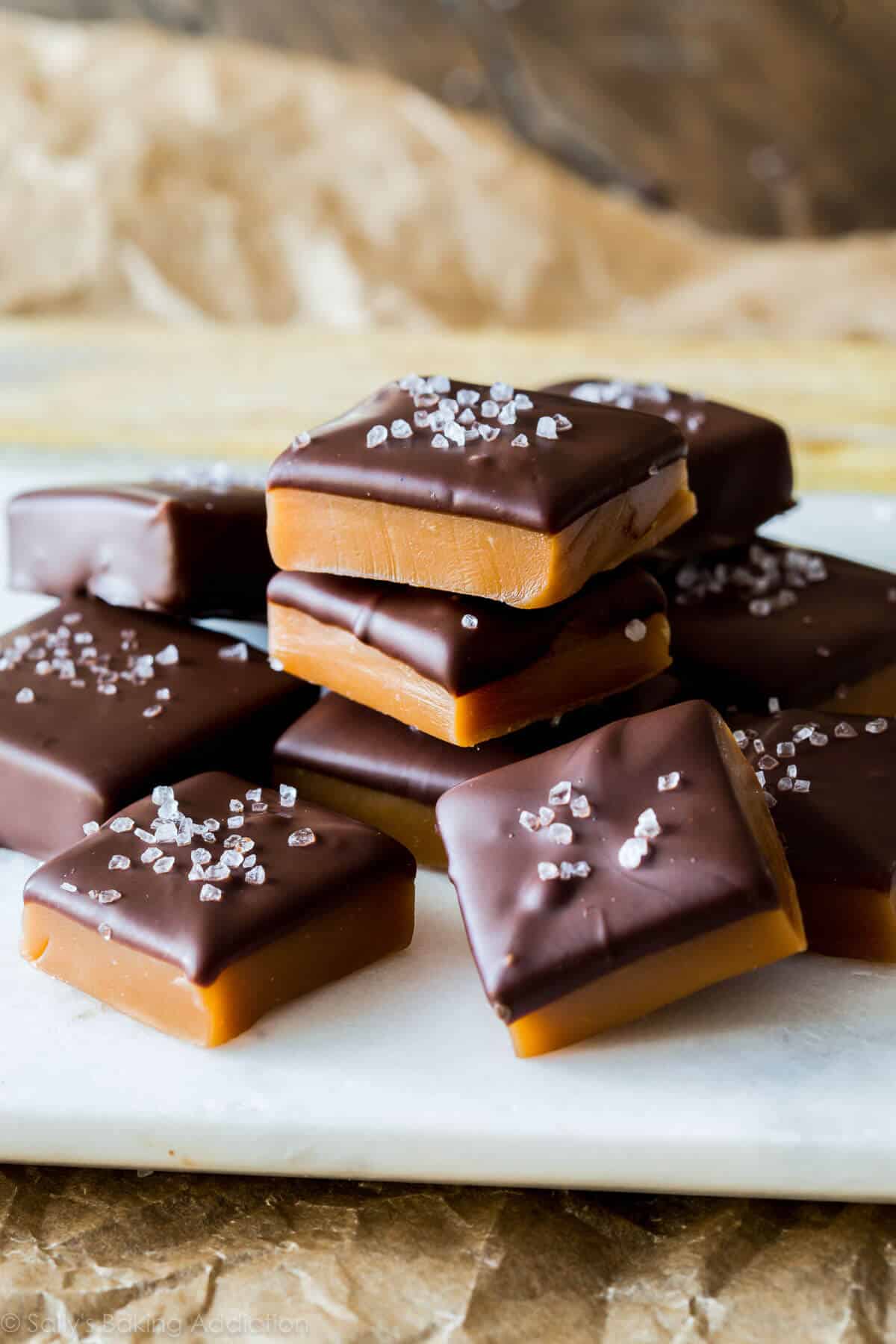 chocolate sea salt caramels stacked on a white serving tray