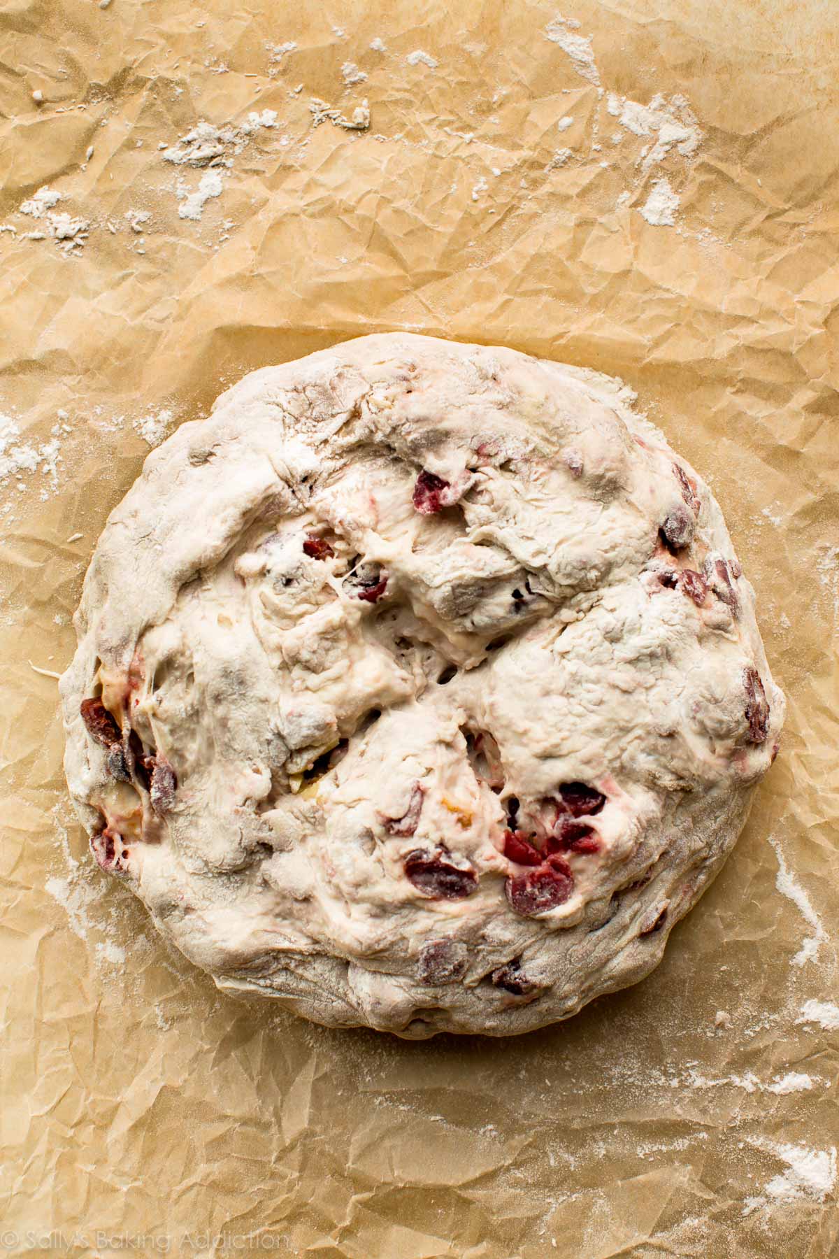 cranberry nut bread in a ball with an x scored on the top