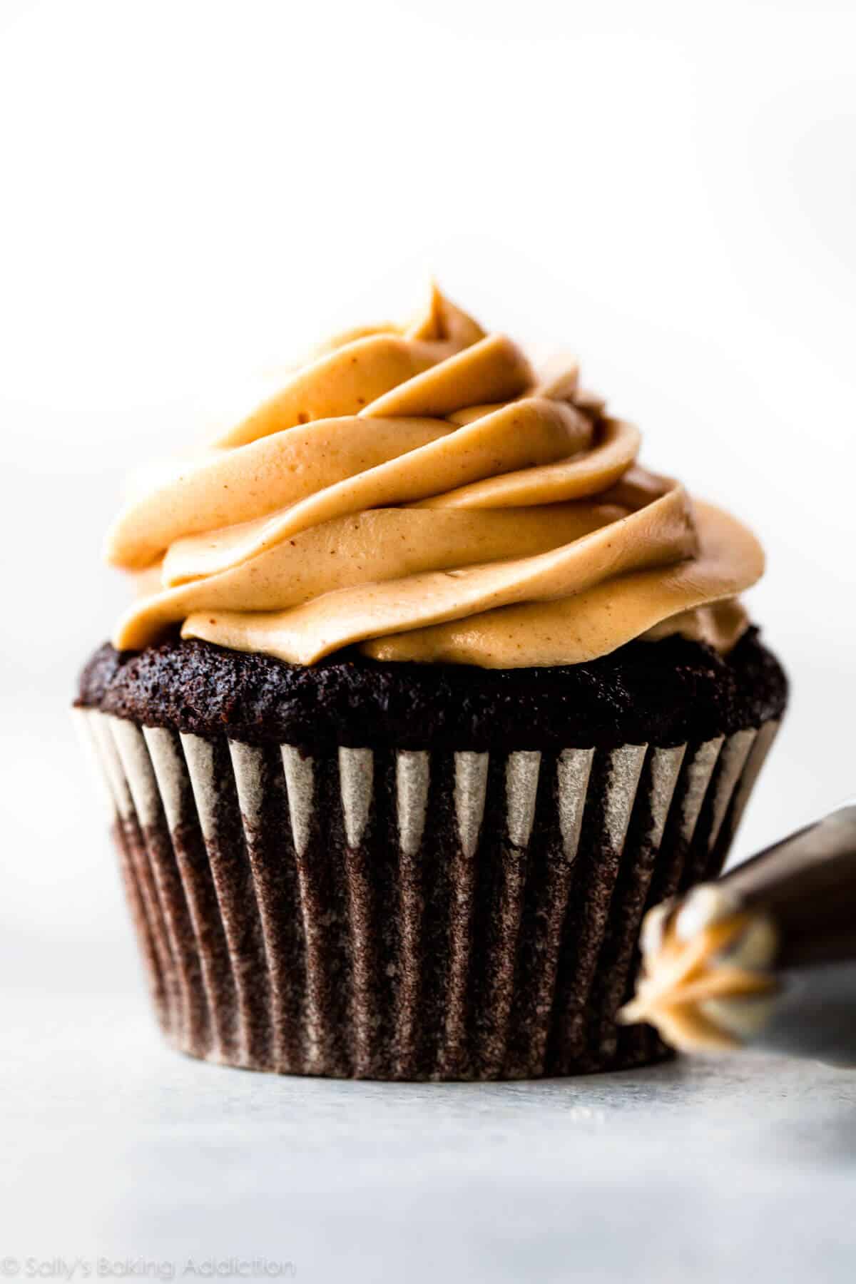 dark chocolate cupcake topped with a swirl of peanut butter frosting