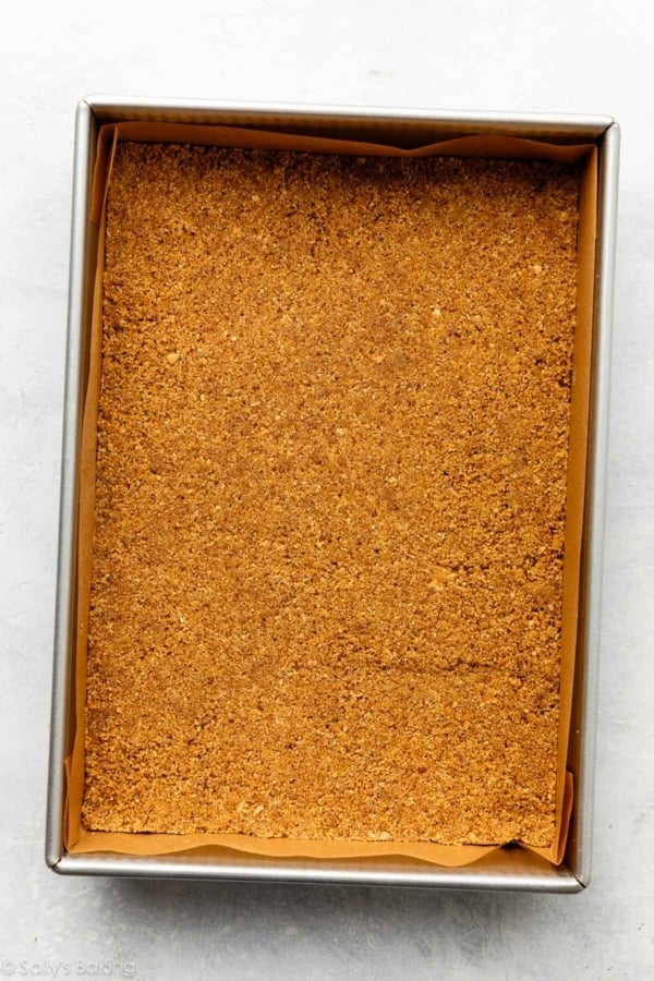 graham cracker crust pressed into a lined baking pan.