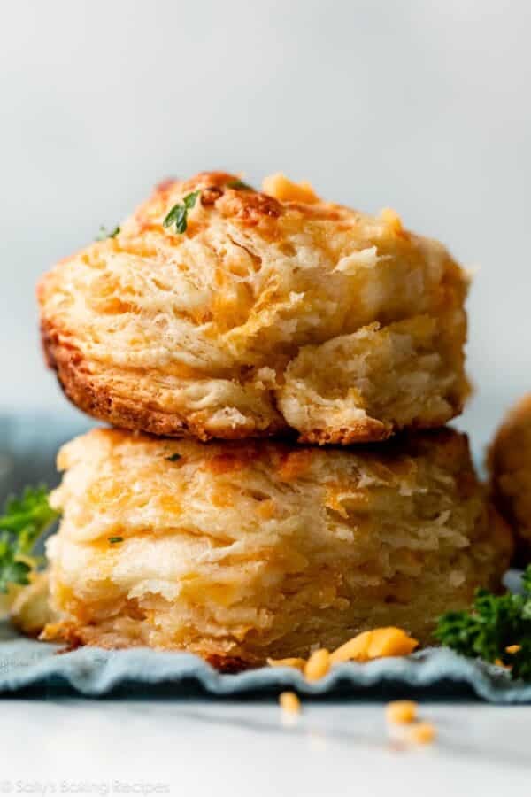stack of two homemade cheddar bay biscuits on blue linen.